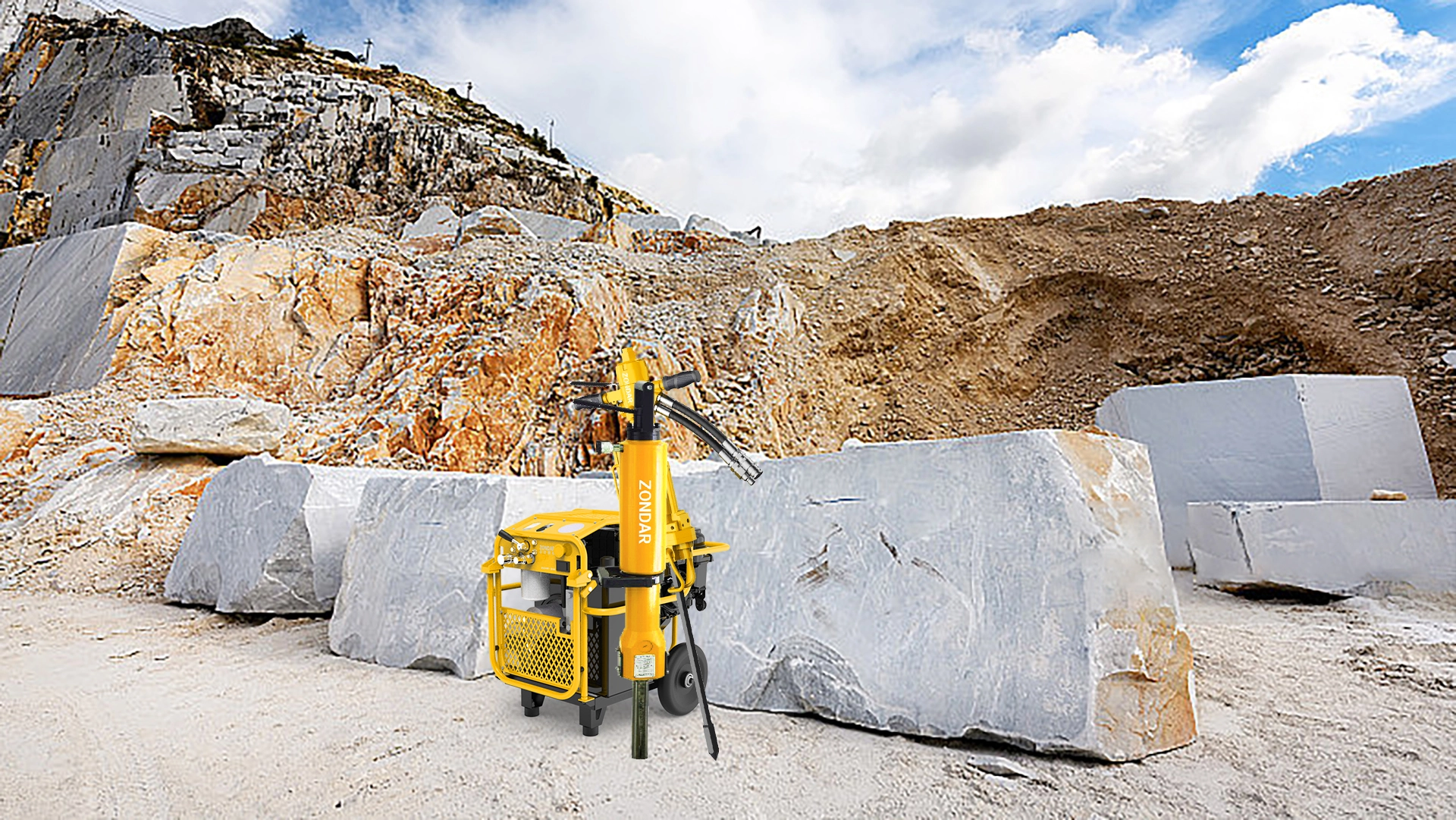 HPU, hydraulic splitter and drill in front of a big rock 